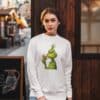 Women's Festive Christmas Sweatshirt - Unique Holiday Print, Grinch Eating Gingerbread Design