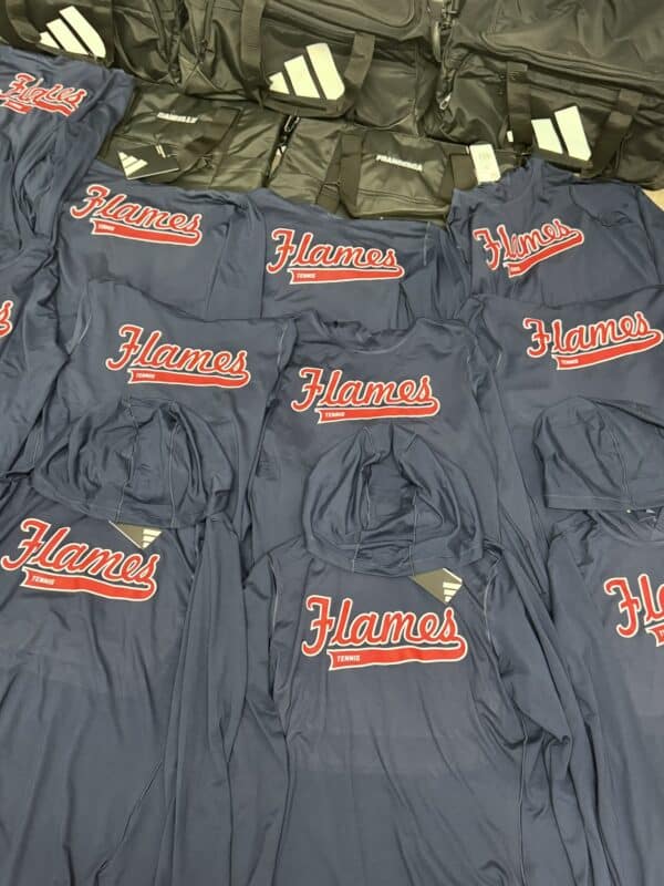 Hooded sweatshirts featuring "Flames" logo in red on navy background, alongside black athletic bags, showcasing sports apparel for Embellishway's product gallery.