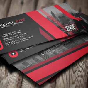 Custom business cards featuring a modern design with a red and black color scheme, displaying contact information, a QR code, and an urban skyline background.