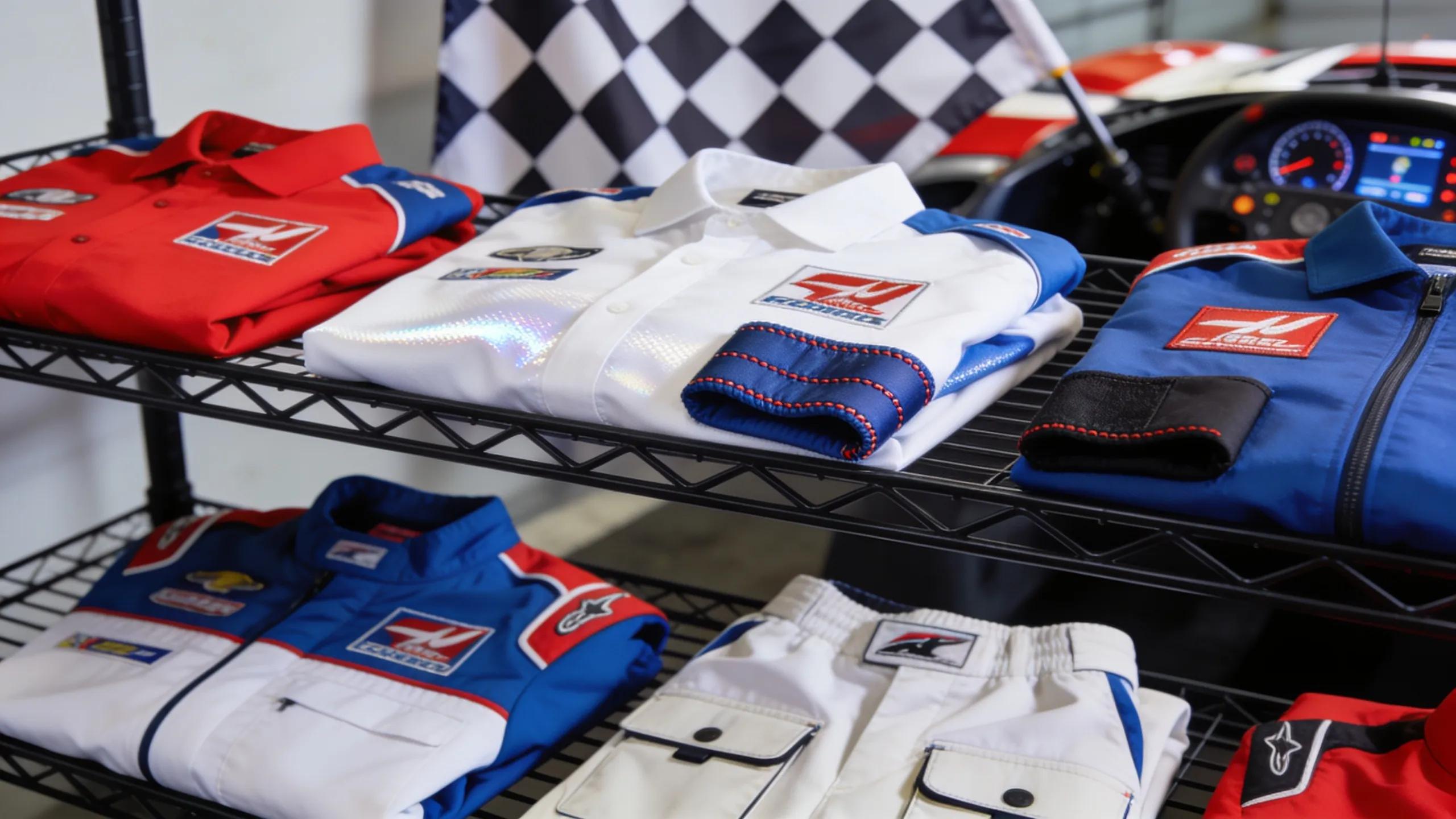 Variety of custom motorsports apparel showcasing vibrant team colors and performance fabrics
